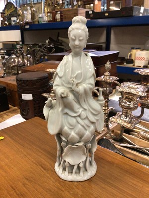 Lot 123 - Antique Chinese blanc de chine figure of Guanyin, shown seated on a lotus base, 22cm high