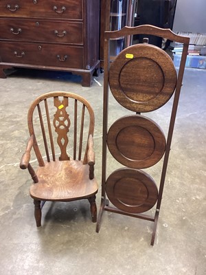 Lot 1140 - Children's wheelback elbow chair together with an oak three tier folding cake stand (2)