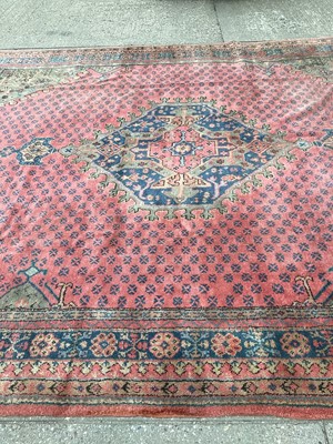 Lot 1159 - Large Turkey pattern rug with central medallion on red, blue and green ground, 408cm x 343cm