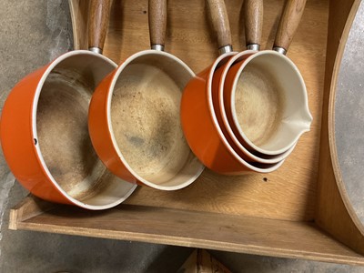 Lot 182 - Graduated set of five Le Creuset lidded saucepans, with hanging shelf, boxed