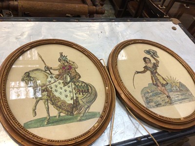 Lot 689 - A pair of Victorian cut paper prints of courtly figures, embellished with fabric and sequins, in gilt oval frames measuring 34.5cm x 29.5cm