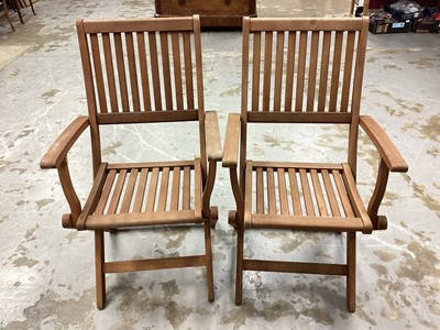 Lot 1166 - Set of six good quality teak folding garden chairs with loose cushions, bearing label Robert Dyas