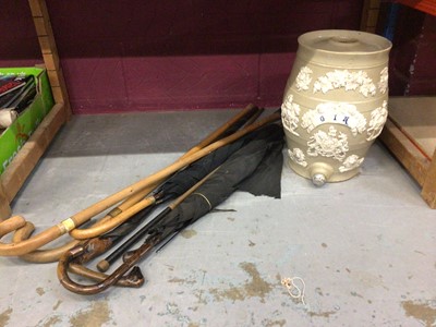 Lot 711 - A Victorian stoneware gin barrel, relief-decorated, together with a group of walking sticks and a 9ct gold topper umbrella