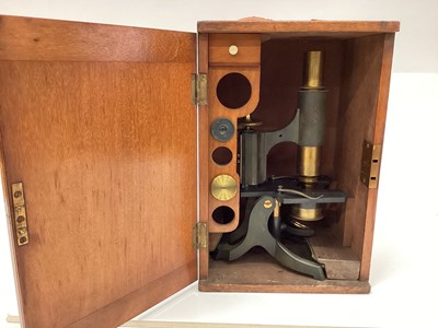 Lot 2510 - Early 20th century brass microscope, with lenses in fitted box