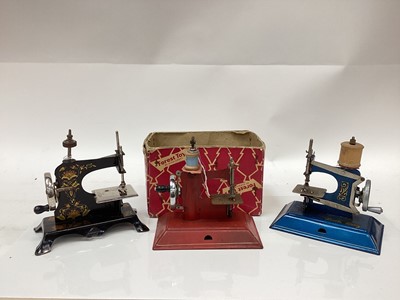 Lot 2520 - Three tinplate toy sewing machines