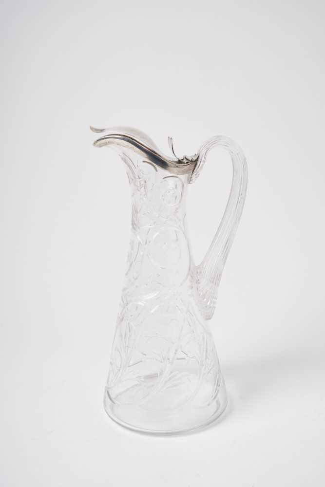 Lot 235 - 19th century French silver mounted cut glass claret jug of tapering form, the body decorated with scrolls and leaves, with reeded handle, the silver cover marked with Minerva's head control mark an...