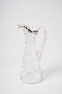 Lot 235 - 19th century French silver mounted cut glass claret jug of tapering form, the body decorated with scrolls and leaves, with reeded handle, the silver cover marked with Minerva's head control mark an...