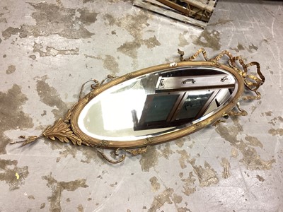 Lot 1209 - Oval bevelled wall mirror with ribbon decoration, 108cm x 39cm, together with a modern mirror (2)