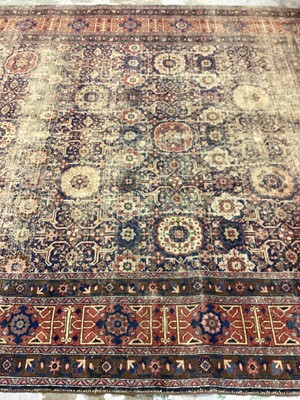 Lot 1216 - Large Eastern rug with geometric decoration on red and blue ground, 322cm x 230cm