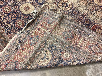 Lot 1216 - Large Eastern rug with geometric decoration on red and blue ground, 322cm x 230cm