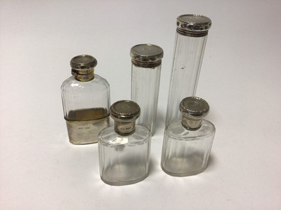 Lot 89 - Set of four silver topped toilet bottles and flask all with Baroness Coronet and monogram