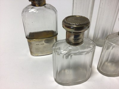 Lot 89 - Set of four silver topped toilet bottles and flask all with Baroness Coronet and monogram