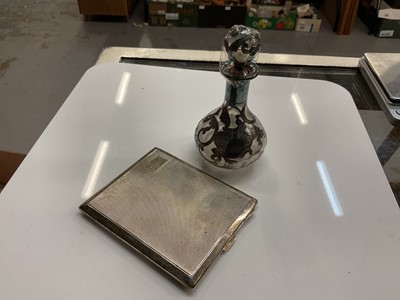 Lot 865 - Silver cigarette case together with a silver overlaid glass scent bottle (2)