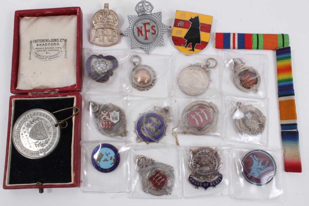 Lot 894 - Group of silver fobs, military badges, medallion etc within a brass cigar box