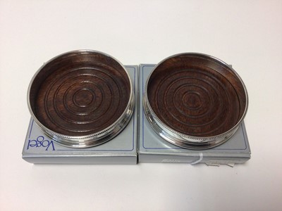 Lot 47 - Pair of sterling silver and turned wood bottle coasters in original Vogel boxes