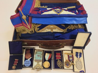 Lot 674 - Group of mainly 1930s -  50s Masonic Regalia to include silver, silver gilt and gilt metal jewels and sash and apron, all contained in a brown leather case.