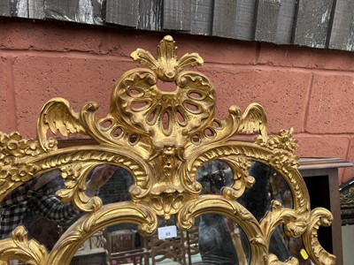 Lot 65 - French-style gilt wall mirror with carved and pierced scroll crestings and mirrored surround