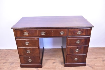 Lot 1200 - Edwardian mahogany twin pedestal desk with an arrangement of nine drawers and oval brass handles