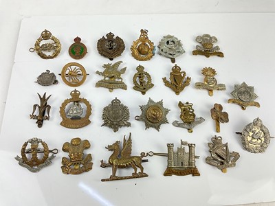 Lot 451 - Collection of twenty five British military cap badges to include 4th Royal Irish Dragoon Guards, The Royal Dragoons and Caernarvon & Denbigh Yeomanry, a mixture of reproduction and original badges...