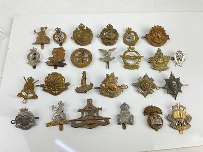 Lot 452 - Collection of twenty five British and Commonwealth military cap badges to include, Selous Scouts, Army Educational Corps and Norfolk Reigment, a mixture of reproduction and original badges noted.