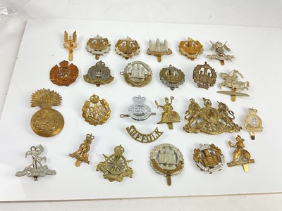 Lot 453 - Collection of twenty five British military cap badges to include The Essex Regiment, The Norfolk Regiment and The Suffolk Regiment, a mixture of reproduction and original badges noted.