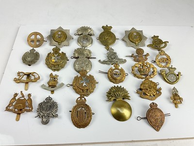 Lot 454 - Collection of twenty five British military cap badges to include King's Own Malta Regiment, Royal Welsh Fusiliers and Royal Engineers, a mixture of reproduction and original badges noted.