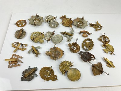 Lot 454 - Collection of twenty five British military cap badges to include King's Own Malta Regiment, Royal Welsh Fusiliers and Royal Engineers, a mixture of reproduction and original badges noted.