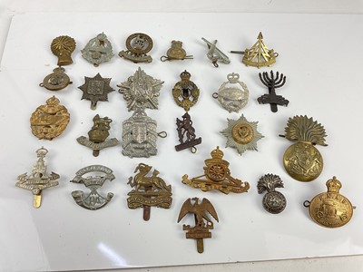 Lot 455 - Collection of twenty five British military cap badges to include Tank Corps, Second Life Guards and Guards Machine Gun Corps, a mixture of reproduction and original badges noted.