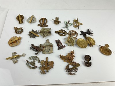 Lot 455 - Collection of twenty five British military cap badges to include Tank Corps, Second Life Guards and Guards Machine Gun Corps, a mixture of reproduction and original badges noted.