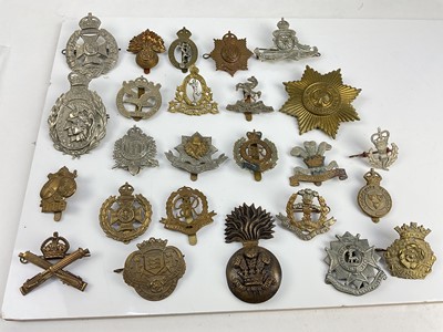 Lot 456 - Collection of twenty five British military cap badges to include Glider Pilot Regiment, Royal Engineers and Machine Gun Corps, a mixture of reproduction and original badges noted.