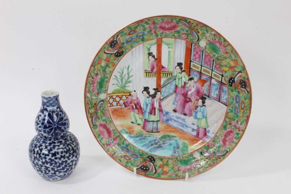 Lot 11 - 19th century Chinese Canton porcelain plate with painted polychrome figures within a border of flowers and butterflies
