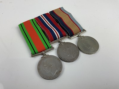 Lot 498 - Second World War Australian medal trio comprising Defence and War medals together with Australia Service medal 1939 - 45, all named to 23687 M. C. Peterson.