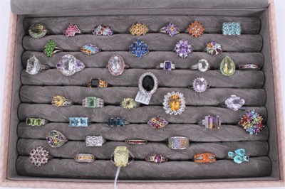 Lot 822 - Collection of 43 silver gem set dress rings displayed in a ring tray