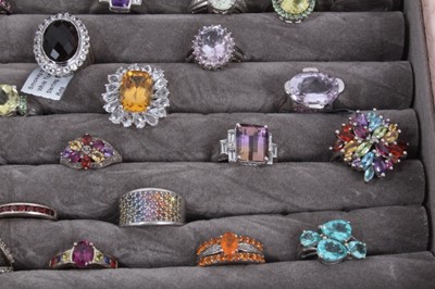 Lot 822 - Collection of 43 silver gem set dress rings displayed in a ring tray