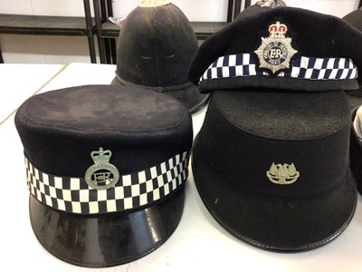 Lot 551 - Group of seven Elizabeth II Police helmets and hats for Royal Ulster Constabulary, Essex Police, The Metropolitan Police and others (1 box)