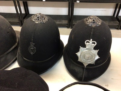Lot 551 - Group of seven Elizabeth II Police helmets and hats for Royal Ulster Constabulary, Essex Police, The Metropolitan Police and others (1 box)