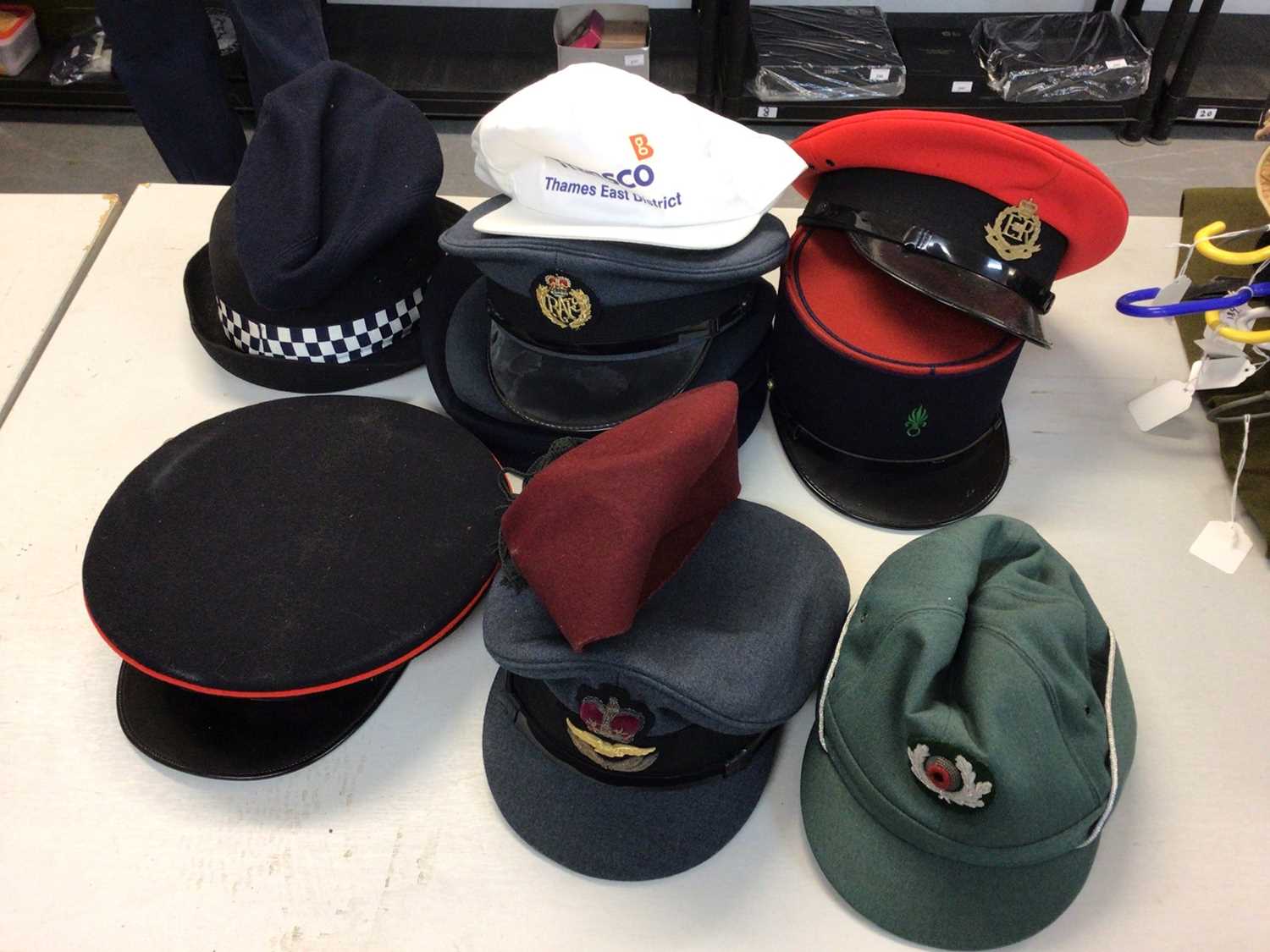 Lot 555 - One box of various military and police hats and helmets including a Kepi and Berets.