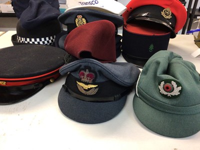 Lot 555 - One box of various military and police hats and helmets including a Kepi and Berets.