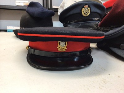 Lot 555 - One box of various military and police hats and helmets including a Kepi and Berets.