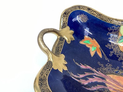 Lot 1274 - Carlton Ware Chinese bird and tree twin handled footed dish printed and painted in colours and another Chinese bird painted in colours on an orange and blue lustre ground