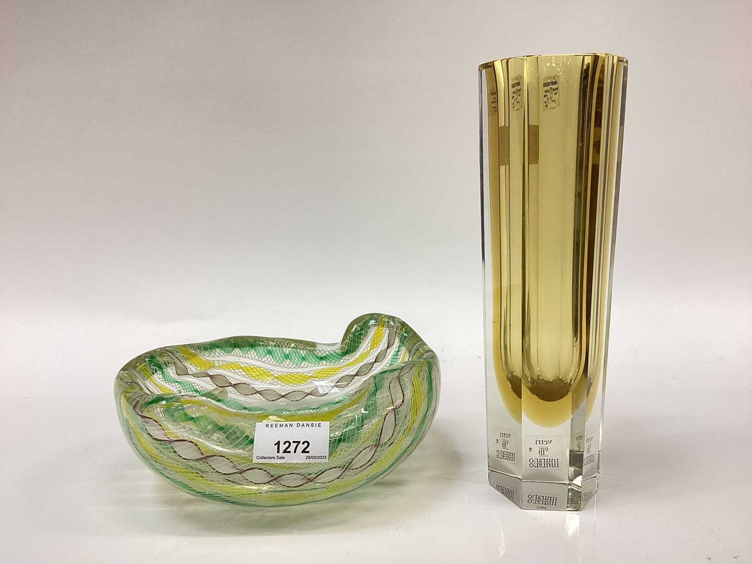Lot 1272 - A Murano glass leaf shaped dish with pinched top rim alterate yellow, green, white canes cased in clear glass.  Together with a slim six sided panel glass with Murano labels