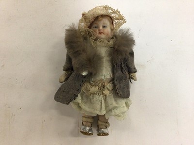 Lot 1977 - A miniature bisque doll stamped Germany 881 with early clothes, shoes etc