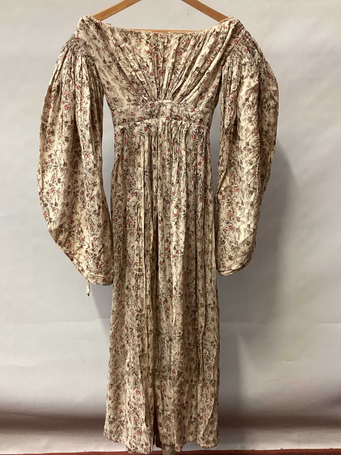 Lot 2110 - 1837 Victorian maternity day dress in Indian printed cotton, bodice has feeding openings with tiny button fastenings, large gigot sleeves, gathered bodice front and back and high waistline.