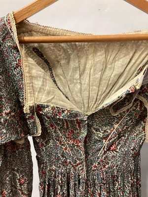Lot 2111 - 1834/1835 Georgian maternity day dress in Indian printed cotton with tiny crochet edging, bodice has feeding openings which have been closed with small stitches. Large gigot sleeves narrowing to...