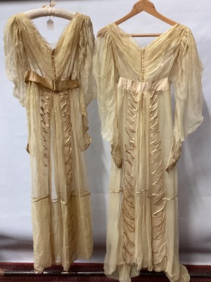 Lot 2112 - 1832 pair Georgian silk gauze dresses with satin trims, intended to be worn over an outer dress, worn as bridemaid dresses. High waisted , one with original ribbon belt and buckle, gigot sleeves (...