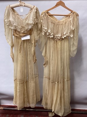 Lot 2112 - 1832 pair Georgian silk gauze dresses with satin trims, intended to be worn over an outer dress, worn as bridemaid dresses. High waisted , one with original ribbon belt and buckle, gigot sleeves (...