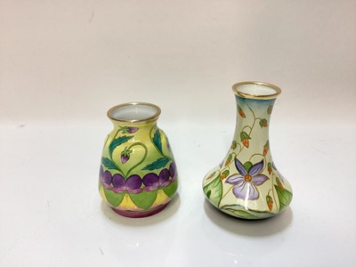 Lot 1247 - Moorcroft enamel Sweet Thief  pattern vase, together with another decorated with purple flowers (2)