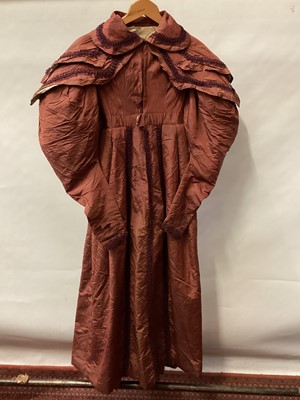 Lot 2114 - 1832 Georgian Carriage dress maroon silk with double cape collar trimmed with braid, padded and gathered skirt.