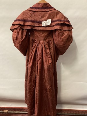 Lot 2114 - 1832 Georgian Carriage dress maroon silk with double cape collar trimmed with braid, padded and gathered skirt.