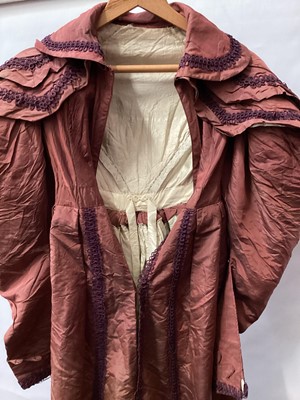 Lot 2114 - 1832 Georgian Carriage dress maroon silk with double cape collar trimmed with braid, padded and gathered skirt.